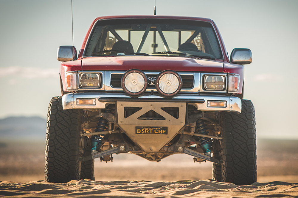 red toyota pickup prerunner with long travel suspension, king shocks and nitto tires